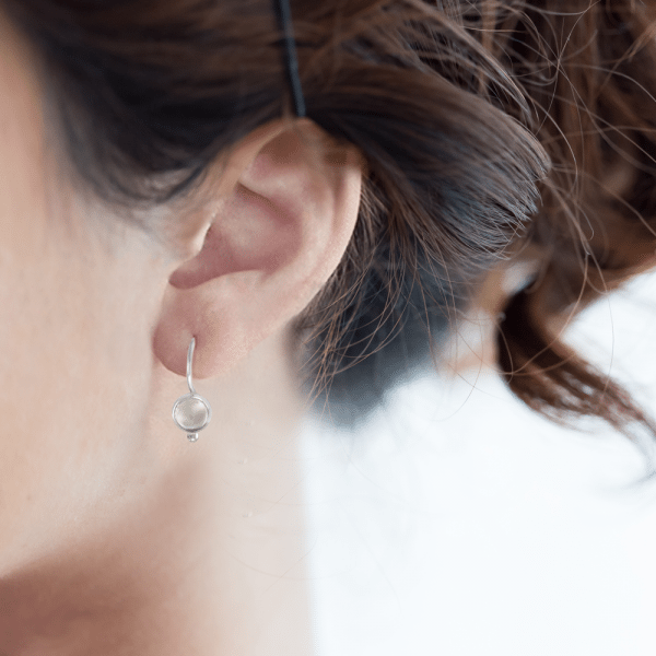 silver moonstone drop earrings on model