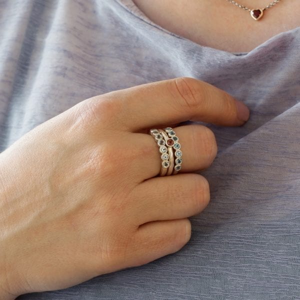 Silver Seven Stone Ring stacked with Silver Flute Ring by Scarab Jewellery Studio